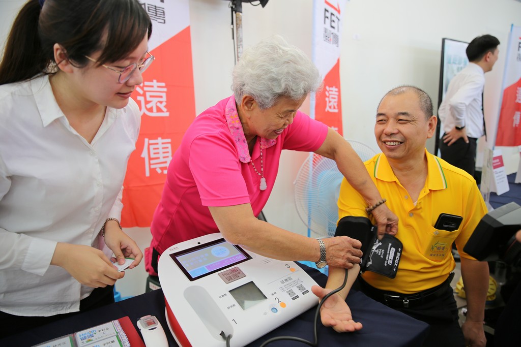 串聯社區診所、銀髮福氣站及部落文化健康站，整合科技照護功能，使醫療照護科技能進駐吉安鄉偏遠地區，高齡八十歲的福氣站志工邱桂蘭(中)在福氣站為民眾測量血壓，提供鄉親便捷的醫療照護網。