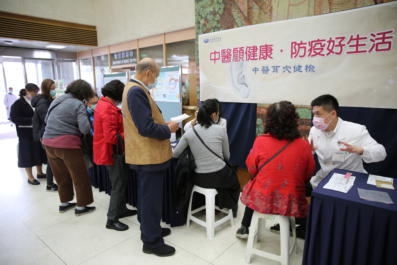 花蓮慈院中醫部團隊為候診的病人及家屬做耳穴健檢，幫助他們更了解自己的體質，進而提升身體的抵抗力來抵抗外在的邪氣。